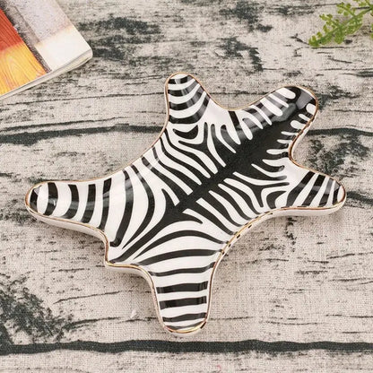 Star-shaped ceramic jewelry holder tray with black and white zebra stripes and a gold tiger skin rim for bedroom decor