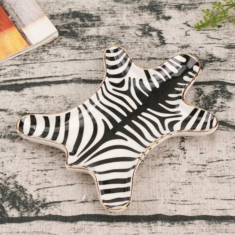 Star-shaped ceramic jewelry holder tray with black and white zebra stripes and a gold tiger skin rim for bedroom decor