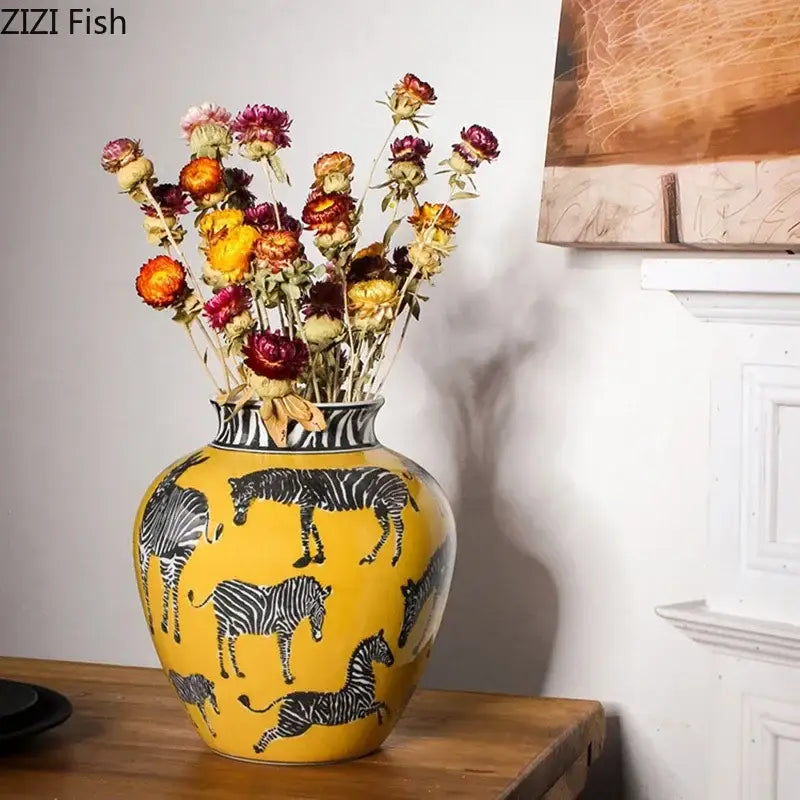 A vibrant yellow ceramic zebra yellow vase with black and white zebra patterns and artificial flowers for desk decoration