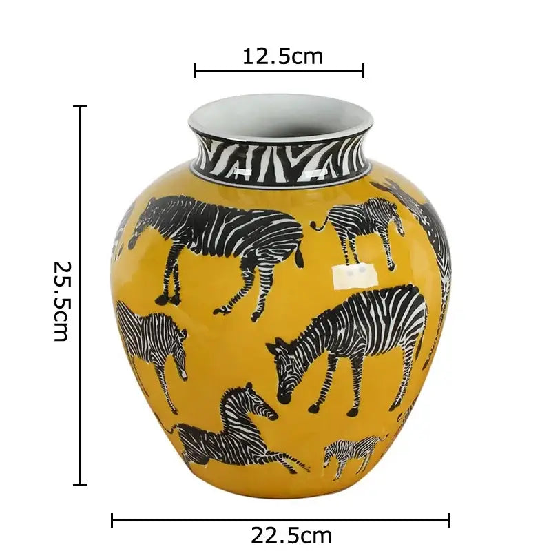 A vibrant yellow ceramic zebra yellow vase with black and white zebra illustrations holding artificial flowers for desk decoration