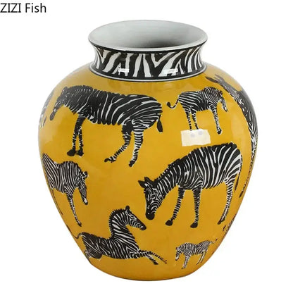 A vibrant yellow ceramic zebra yellow vase with black and white zebra illustrations holding artificial flowers for desk decoration