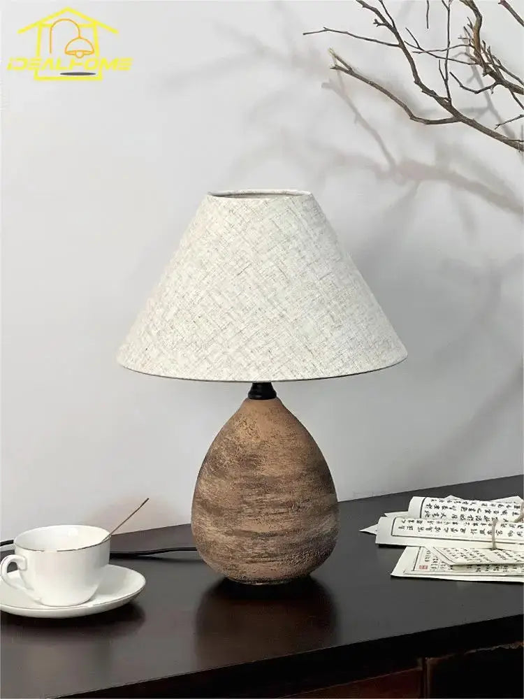 Earthenware teardrop-shaped zen earthy textured ceramic jar led table lamp with natural brown base and beige fabric shade for living room decor