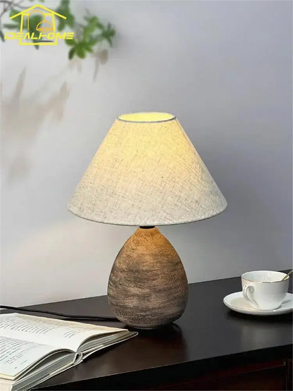 Rustic teardrop-shaped decorbites ceramic jar led table lamp with textured brown base and beige linen shade for living room decor