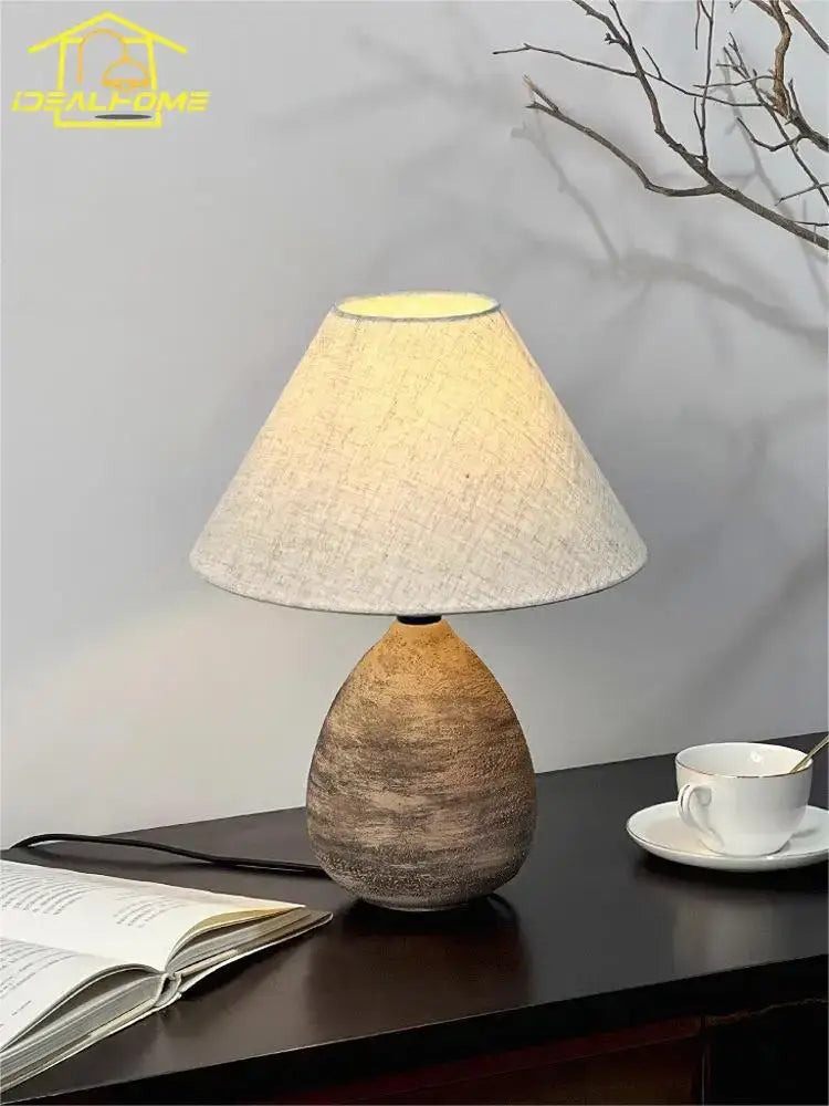 A warm-toned decorbites ceramic jar led table lamp with earthy textured ceramic jar and soft beige linen shade for living room