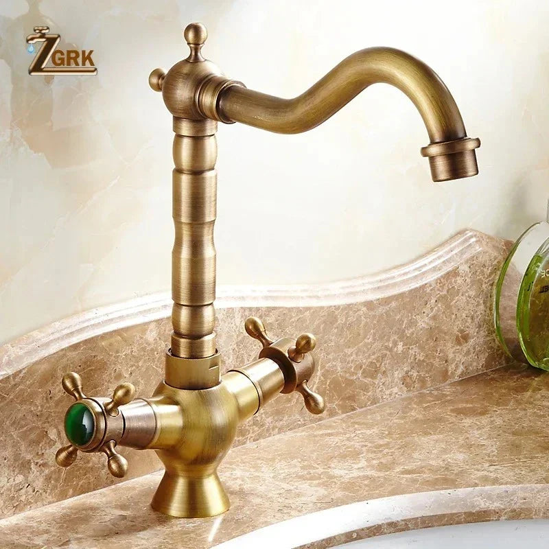 Antique brass deck mounted kitchen faucet with dual cross handles, green gemstone accent, and 360 rotation mixer tap