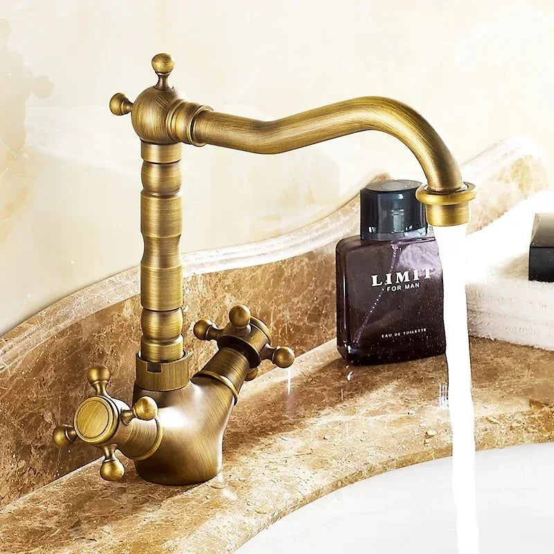 Antique brass-finished dual handles basin faucet with ornate turned spout deck mounted single hole housing material