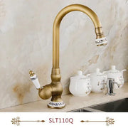 Gold-toned deck mounted single hole kitchen faucet with curved spout and porcelain accents in antique brass housing material
