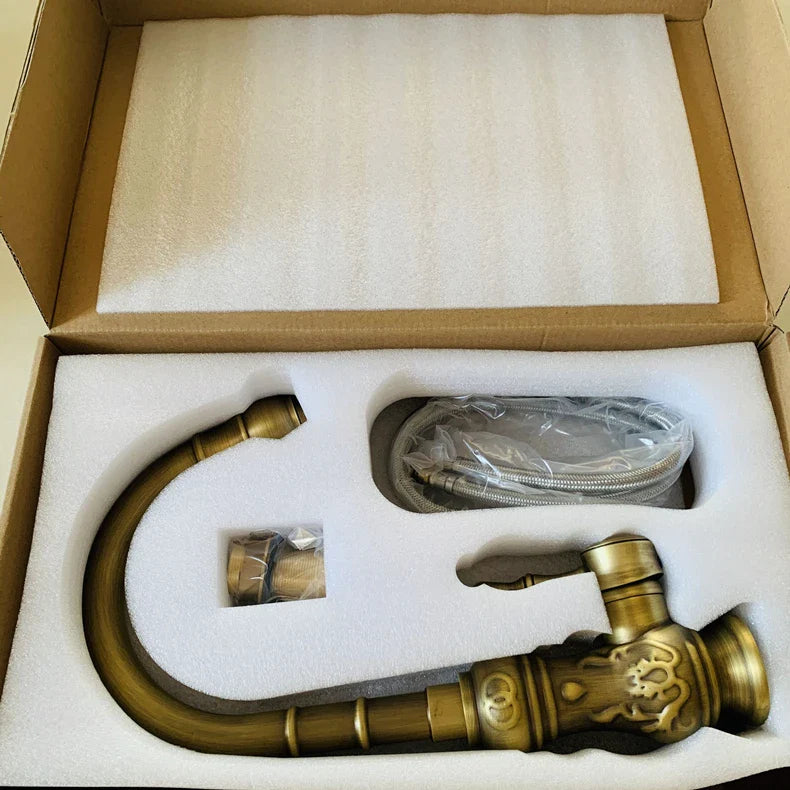 Antique brass single hole mixer tap with ornate design and housing material for deck mounted vessel sink use
